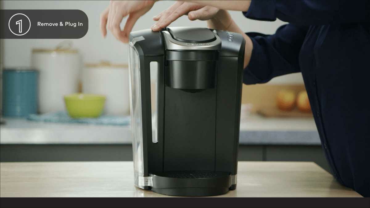 Remove the Keurig coffee maker from the box and any adhesive tape and place it in its new home.