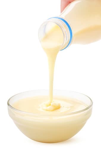 Condensed milk from the package is poured into a plate 