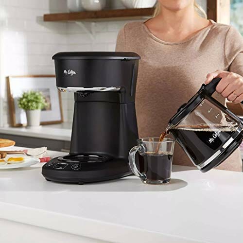 A woman pouring cofffe by Mr. Coffee Coffee Maker