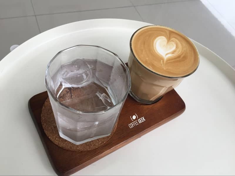 A latte enjoyed with a glass of iced water