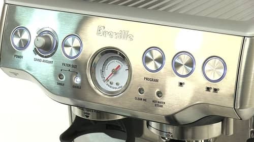  Breville Barista Express interface featuring buttons, dials, and an analog pressure gauge