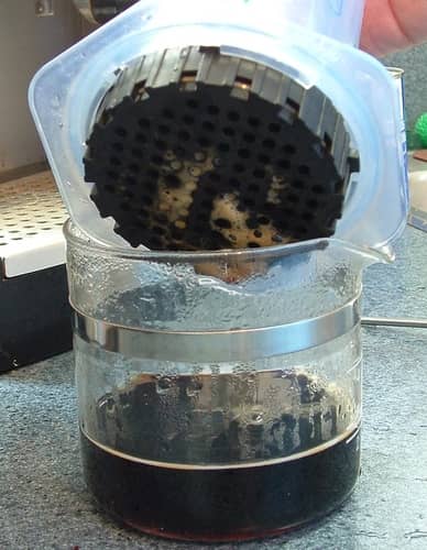 The bottom of the AeroPress filter cap after brewing