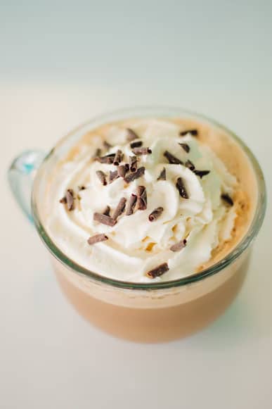 A cup of mocha with whipped cream and chocolate shavings on top