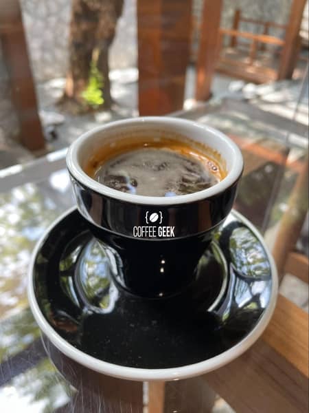 A double shot of espresso served in a demitasse cup