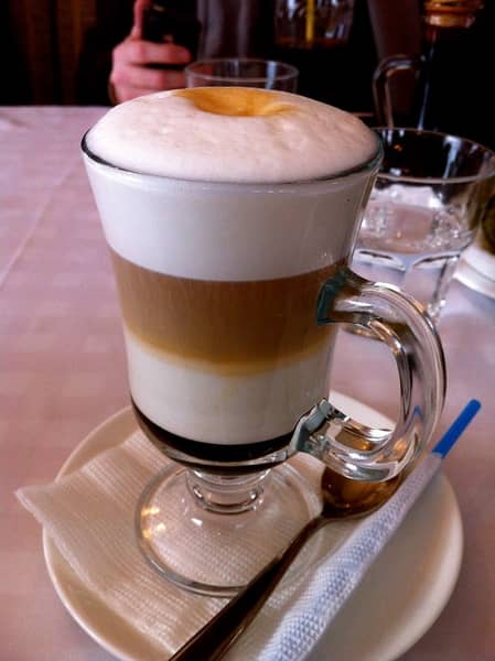 A glass of mochaccino with a very pronounced milk foam