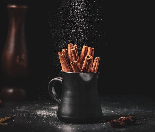 Cinnamon sticks in a black pot