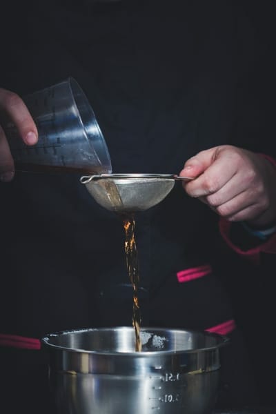 Local barista preparing liquid syrup for a adding to a cold beverage such as iced coffee