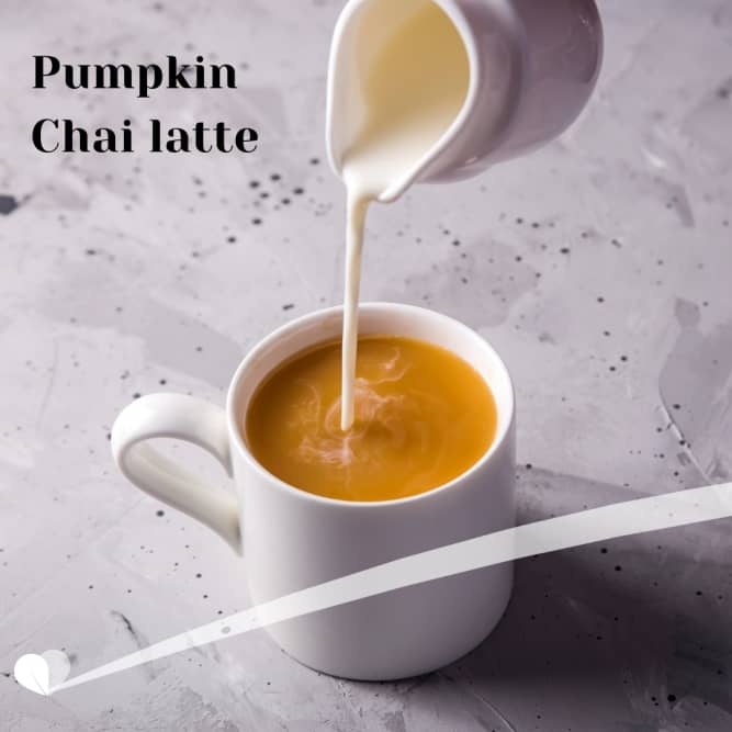 Shot of milk pouring into a cup of caffeine-free Pumpkin Spice Chai Tea Latte