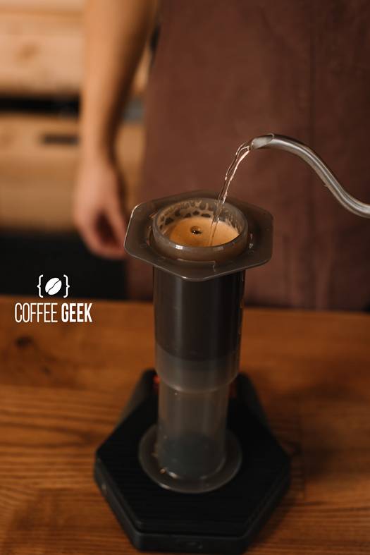 Cropped view of barista pouring water from kettle 