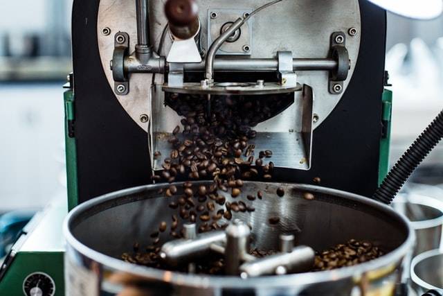 Roasting coffee at the first crack stage in a roaster when coffee beans turn brown and open up
