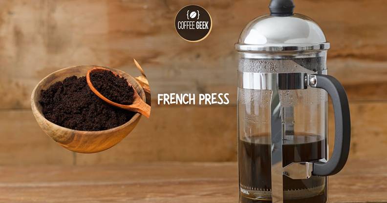 A french press coffee maker next to a bowl of coffee grounds.