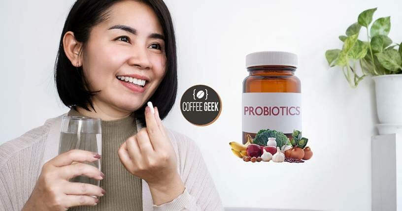 A woman holding a bottle of probiotics and a glass of water.