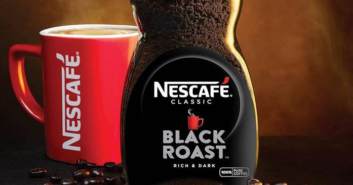 Nescafe black roast coffee next to a cup of coffee.