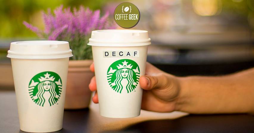 Two starbucks cups with the word decaf on them.