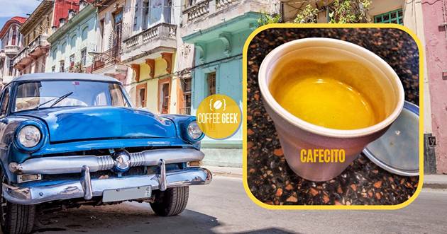 A cup of coffee and a blue car on a street in havana. 