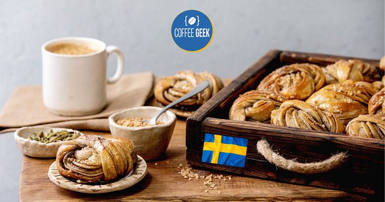 Swedish pastries in a wooden box with a cup of coffee.