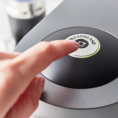 A person pressing a button on a coffee machine.