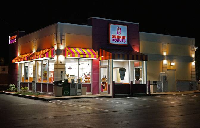 An image of a dunkin donuts at night.