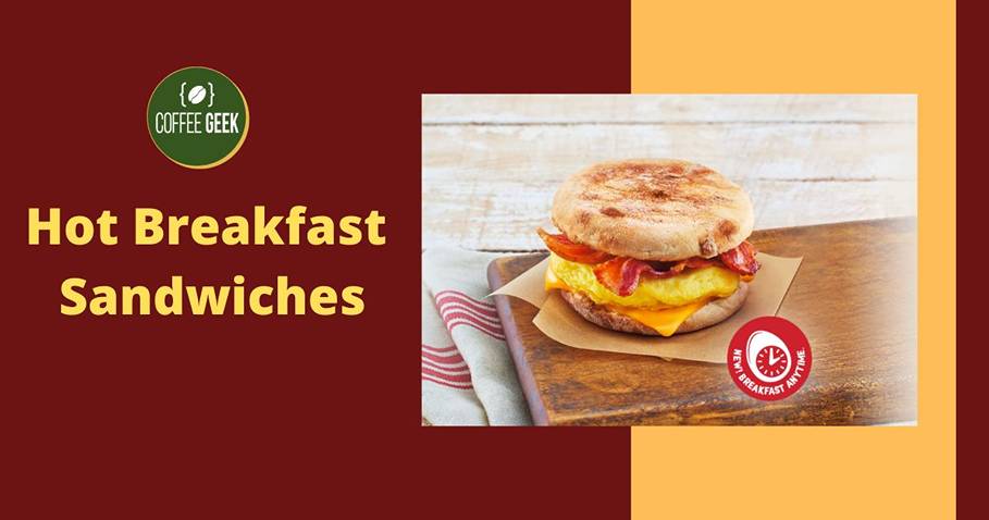 Hot breakfast sandwiches on a wooden table.